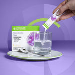 sachet of Herbalife Nutrition Microbiotic Max being poured into glass of water with product box next to it